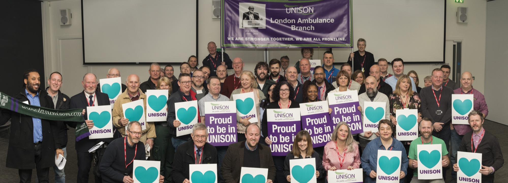 London Ambulance Service UNISON members together at the branch AGM, holding ‘Proud to be UNISON’ cards